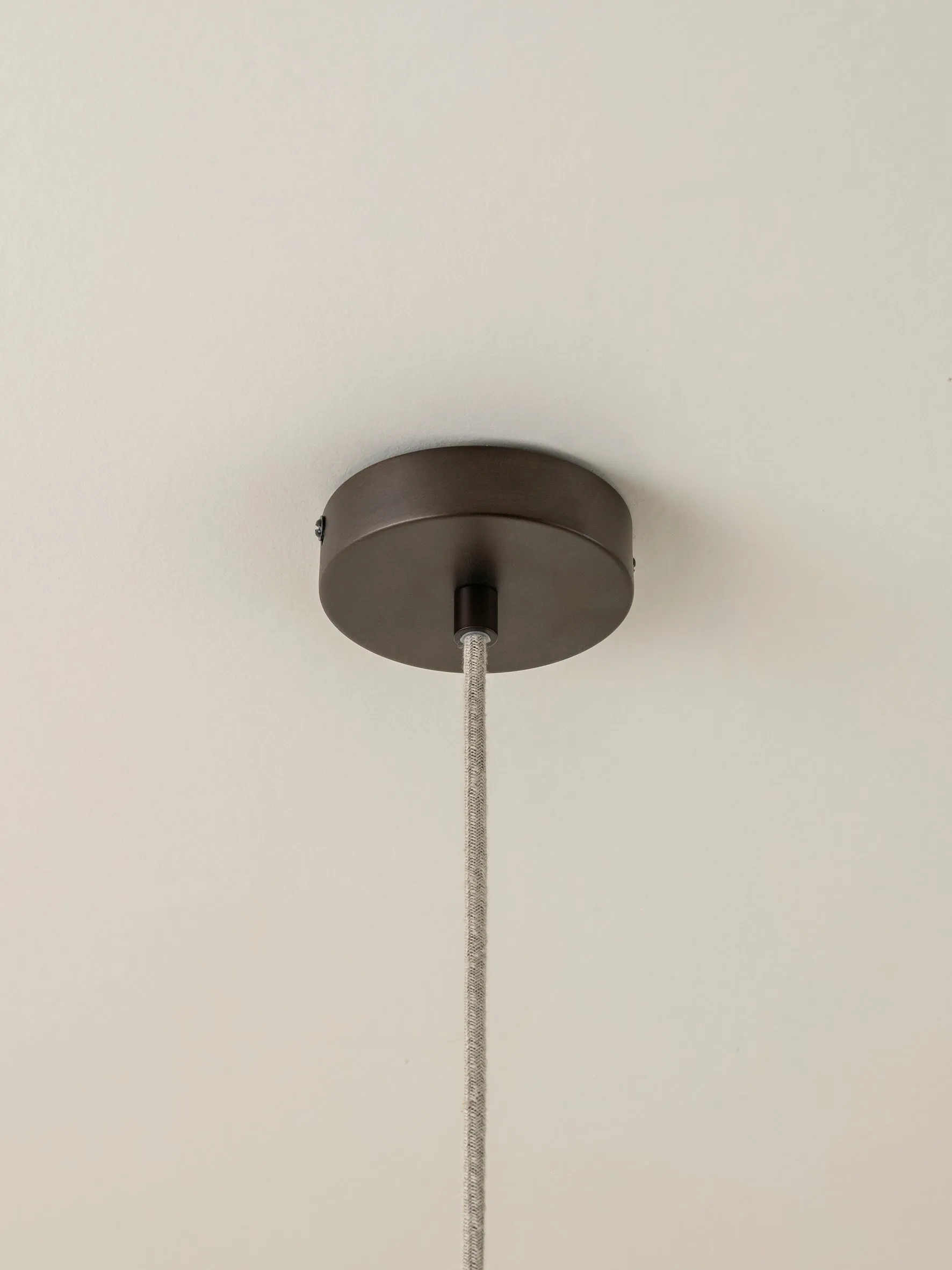 Solara - small dark bronze and layered natural linen pendant